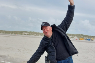 Buitenhof Reizen voor mensen met een verstandelijke beperking - Jongeren - Genieten op Terschelling - reiziger met handen in de lucht op het strand Buitenhof Reizen voor mensen met een verstandelijke beperking - Jongeren - Genieten op Terschelling - reiziger met handen in de lucht op het strand