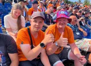 Buitenhof Reizen voor mensen met een verstandelijke beperking - Jongeren -Spa Francorchamps - Twee blije reizigers op de tribune Buitenhof Reizen voor mensen met een verstandelijke beperking - Jongeren -Spa Francorchamps - Twee blije reizigers op de tribune