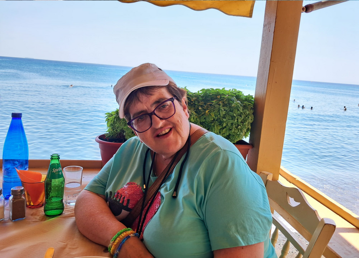 Buitenhof Reizen voor mensen met een verstandelijke beperking - Ondernemend - Vulkanisch Lesbos - reiziger op terras met uitzicht op zee Buitenhof Reizen voor mensen met een verstandelijke beperking - Ondernemend - Vulkanisch Lesbos - reiziger op terras met uitzicht op zee